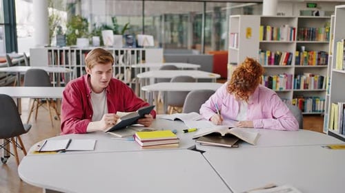 University Freshmen Prepare Homework Together in Library