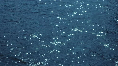 The sea's surface glittered with sparks.