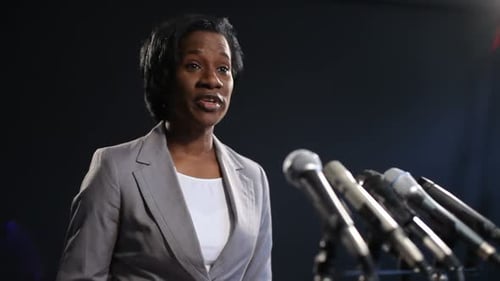 Woman Giving Speech at Press Conference