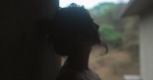 Woman Silhouette in Front of Window