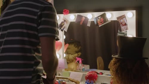 Dressing Room with Adult at Lighted Vanity