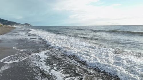 Dramatic Color of the Sea Waves Crashing Against the Rocks Aerial View on a Wild Beach