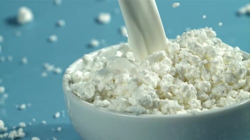 Milk Being Poured into Bowl of Cottage Cheese
