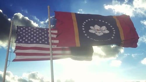 American and Mississippi Flags Waving Under Sunny Sky