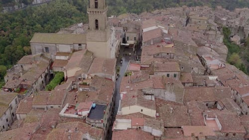 Aerial view of medieval village with cathedral on rocky cliff, Italy.