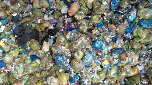 Waste Management Challenges in Urban Areas Shown Through a Large Pile of Garbage on City Streets