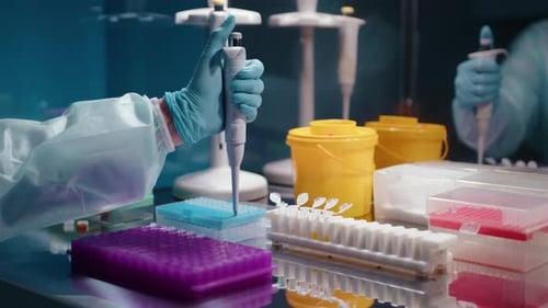 Scientist Pipetting Liquid Samples in Research Laboratory