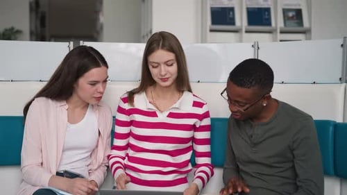 Young Adults Collaborating on Laptop Project