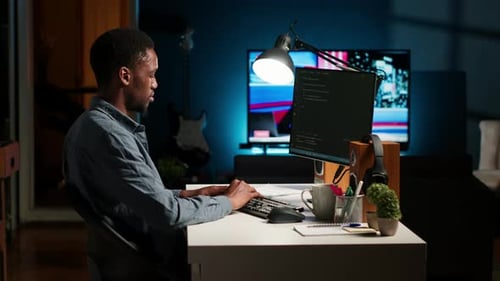 Young Programmer Engineer Writing Binary Code Data on Terminal Window