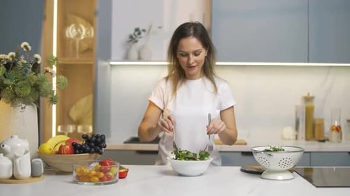 Woman Preparing Healthy Salad in Modern Kitchen