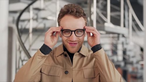 close-up portrait of a curly smiling man with glasses