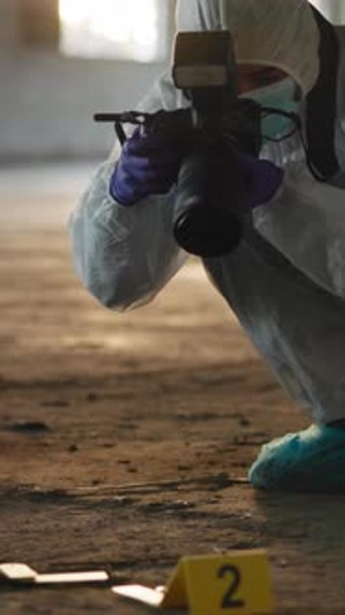 Forensic Investigator Photographs Evidence at Crime Scene