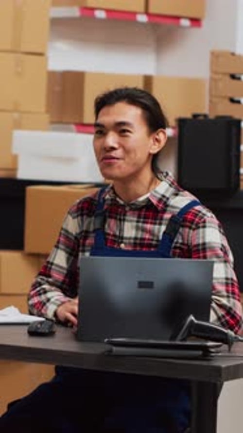 Young Adult Man Presenting at Warehouse Desk