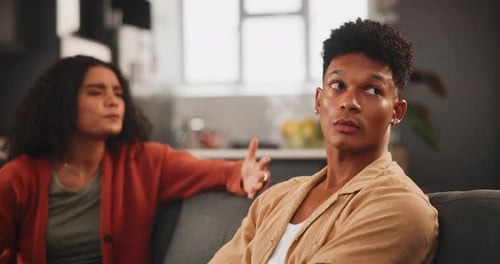 Upset Woman Arguing With Man at Home on Couch