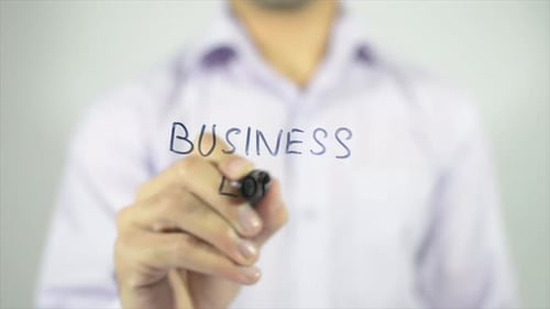 Writing Business Loan on Clear Surface with Marker