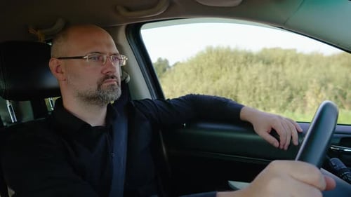 Fahrer, bärtiger Mann, der Auto fährt, Geschäftsmann, der selbstbewusst das Lenkrad hält