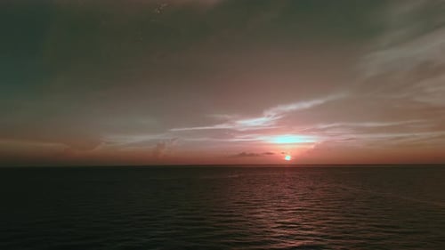 Burning Sky and Shining Waves Ocean Beach Sunsets Aerial Drone Wide Shot Footage