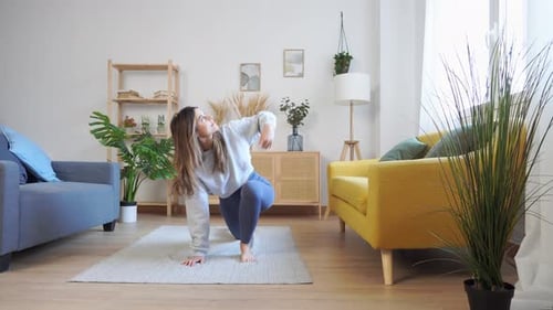 Woman Practicing Yoga Exercise at Home