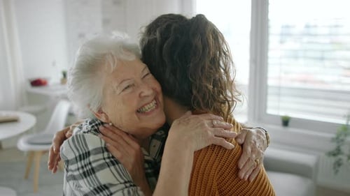 Loving Senior Woman Embraces Her Adult Daughter
