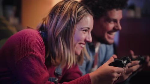 Woman and Man Laughing while Playing Video Game