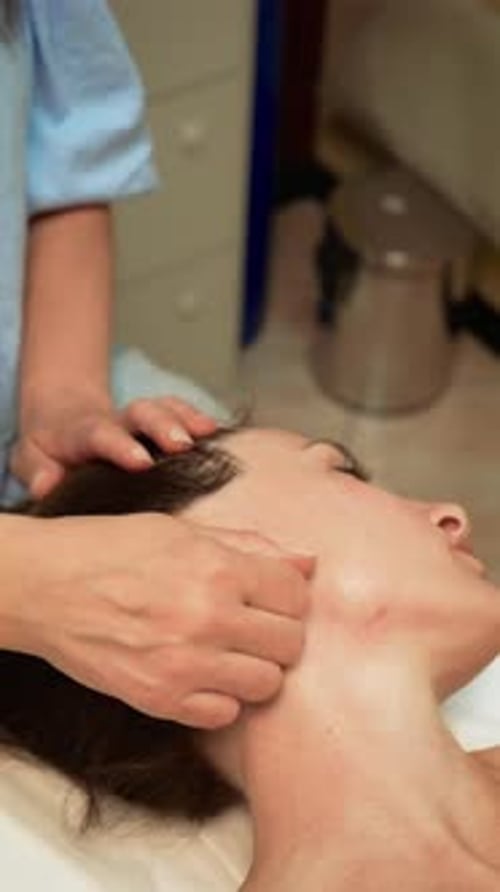 Massage Therapist Performing Deep Tissue Massage on Neck for Relaxation and Rejuvenation Vertical