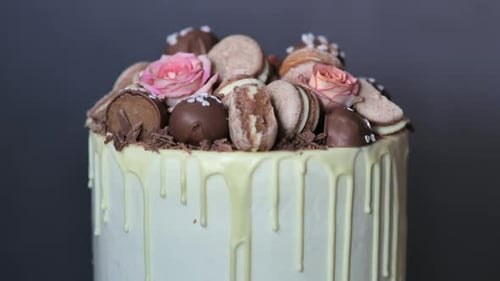 Cake in White Cheese Glaze Decorated with Rose Flowers and Cookies in Rotation