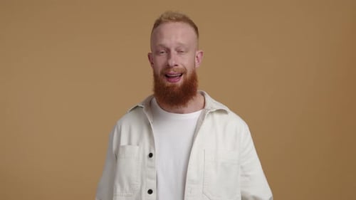 Man Smiles, Winks, and Points Fingers