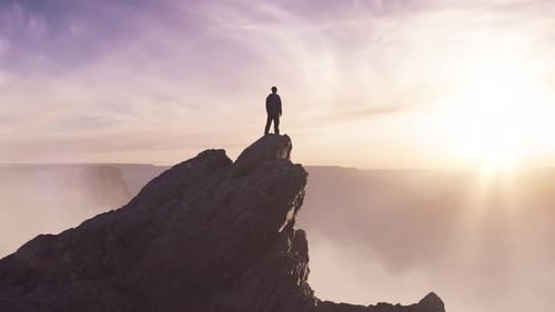 Epic Adventure Composite of Man Hiker on Top of a Rocky Mountain