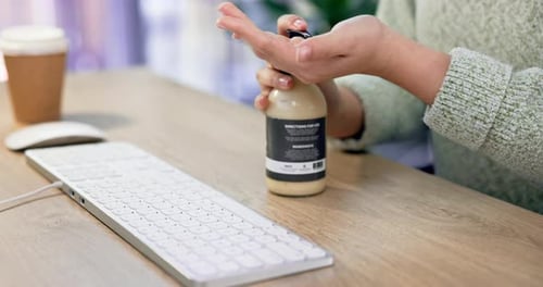 Hand sanitizer, cleaning and computer keyboard in office with hygiene and bacteria safety