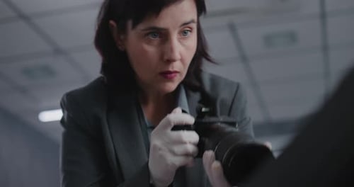 Close Up of Female Forensic Scientist Taking Photos of Evidence at Crime Scene