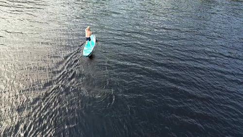 Aerial View Of A Man Standup Paddleboarding In The Lake In Dalarna, Sweden.