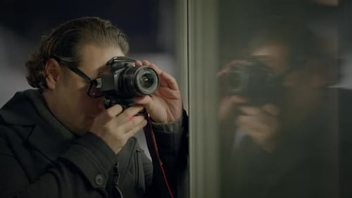 Man Using a Camera in Urban Environment