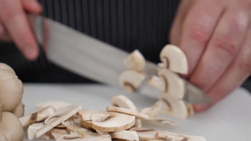 Mushroom Dicing Close-Up on a White Cutting Board
