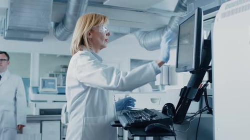 Scientist Using Touchscreen Monitor in Laboratory