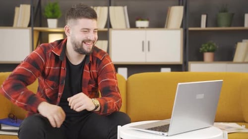 Man Smiling and Talking on Laptop Video Call
