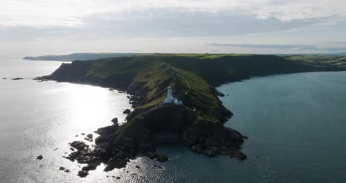 Rocky Coastal Features And Light House On Beautiful Devon Coast Line Aerial Drone Shot
