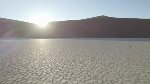 A Girl Walks Along the Dried Up Bottom of a River in the Valley of Dedvlei