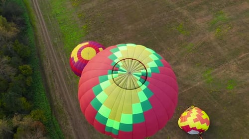 Aerial View of Hot Air Balloons Over Rural Landscape