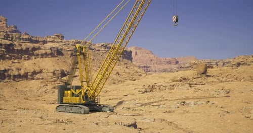 Heavy Machinery Operates in a Desert Landscape During Clear Weather