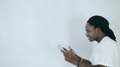 Man Reacts to Content on Tablet Screen