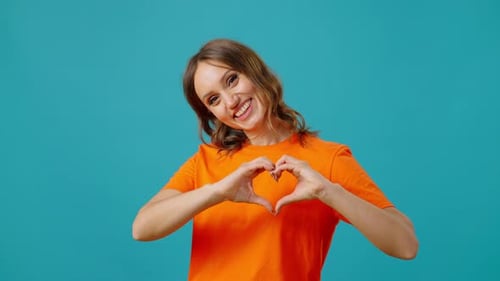 Woman Making Heart Shape with Hands