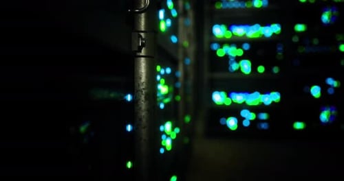 Bright Lights Illuminate Server Racks in a Data Center During Nighttime