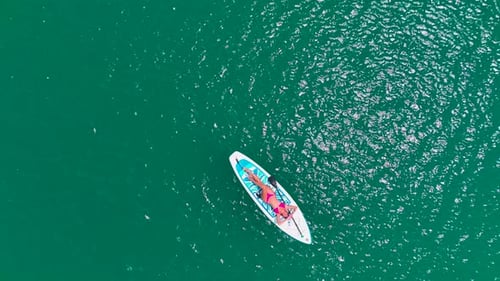 Aerial View Paddleboarding Adventure in the Scenic Green Canyon People Relax and Enjoy the Summer