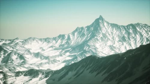 Flying Over Majestic Snow-Covered Mountain Range
