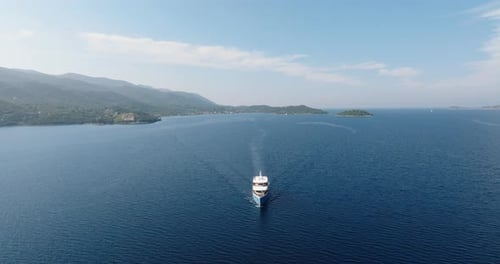 Aerial of a yacht leaving the Dalmatian coast, Croatia