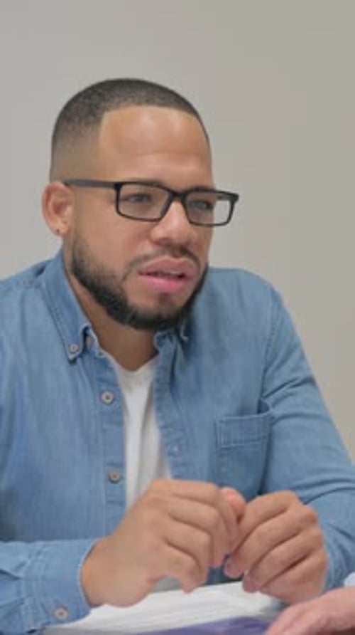 Man in Blue Shirt Speaking in an Office