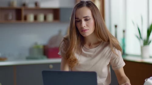 Portrait of Attractive Businesswoman Working on Laptop Computer at Home Office. Relaxed
