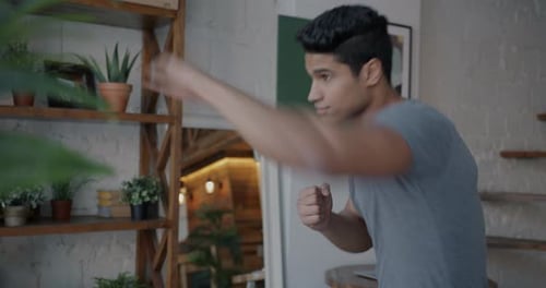 Young Adult Practicing Boxing Punches at Home