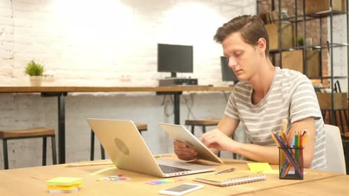 Young Man Using Tablet in Office