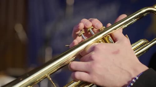 Detail of fingers playing trumpet